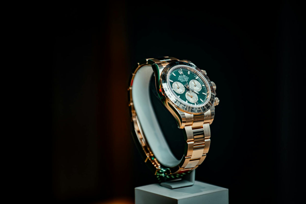 Rolex Daytona with green dial on a display stand